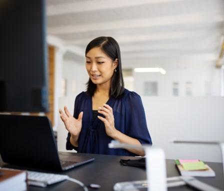 Woman talking and working on computer