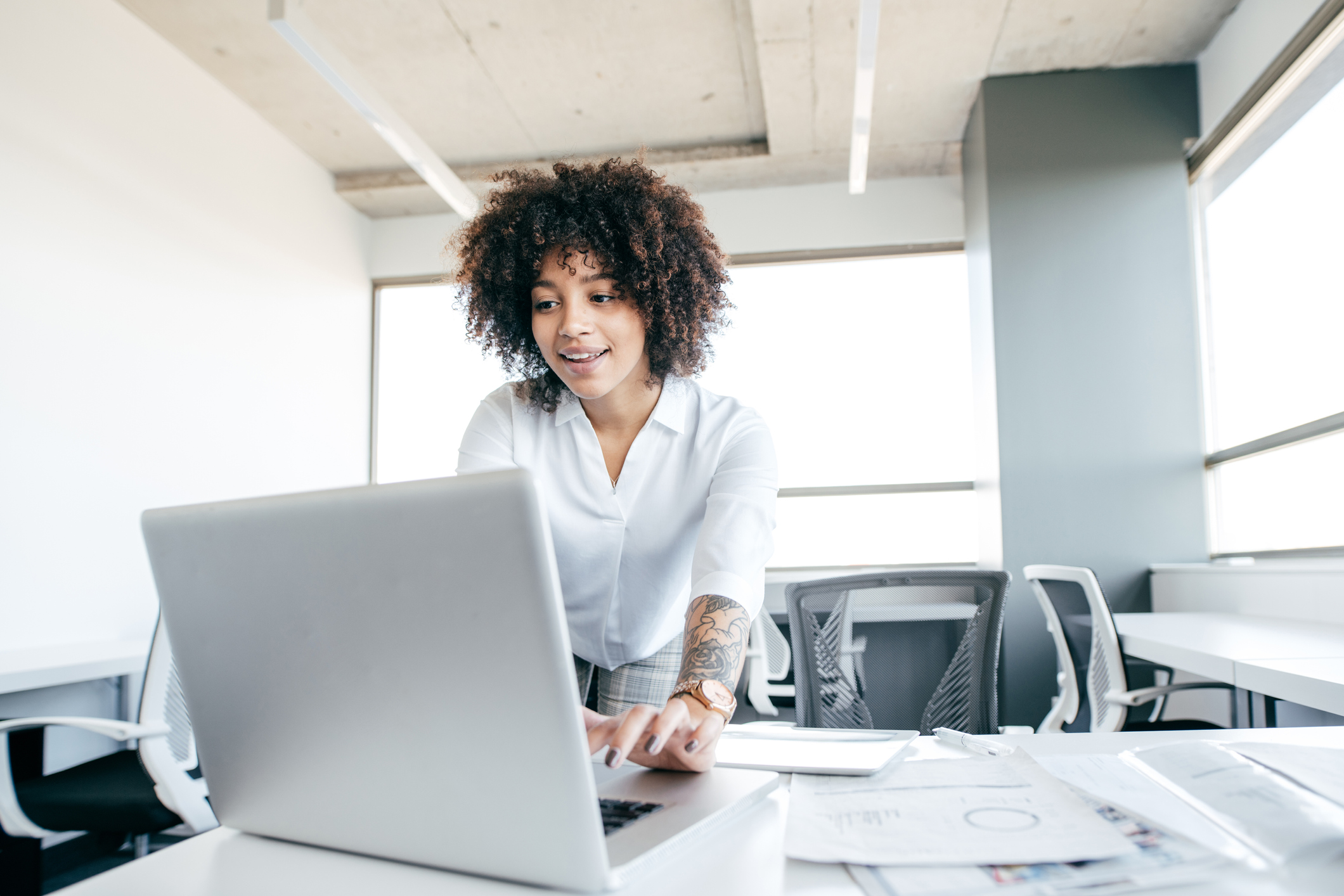 Woman looking at laptop in office