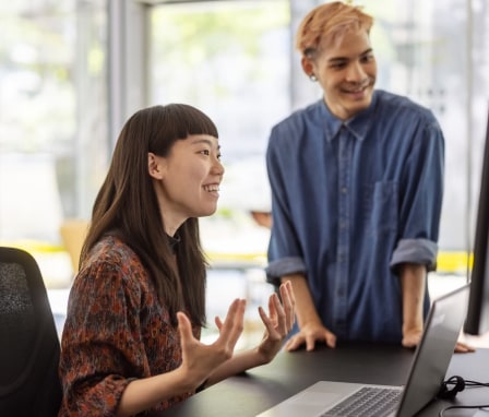 Two colleagues looking at computer screen