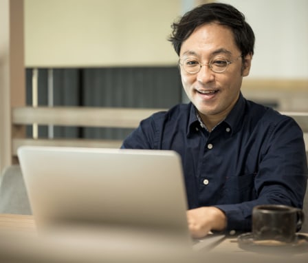 Man typing on laptop at a desk