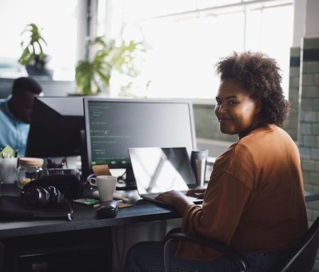 Person coding on laptop at desk